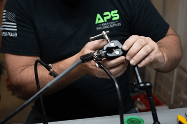 Technician performing certified trenchless equipment repairs at APS facility