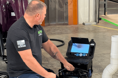 APSTA trainer demonstrating how to use a sewer inspection camera to inspect PVC pipe during hands-on trenchless training.