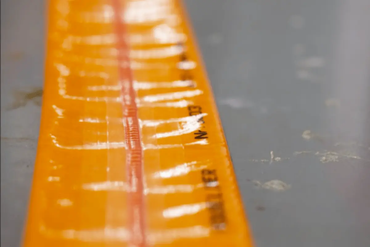 Resin-saturated CIPP pipe liner with TPU coating and center seam laid flat before trenchless pipe lining installation