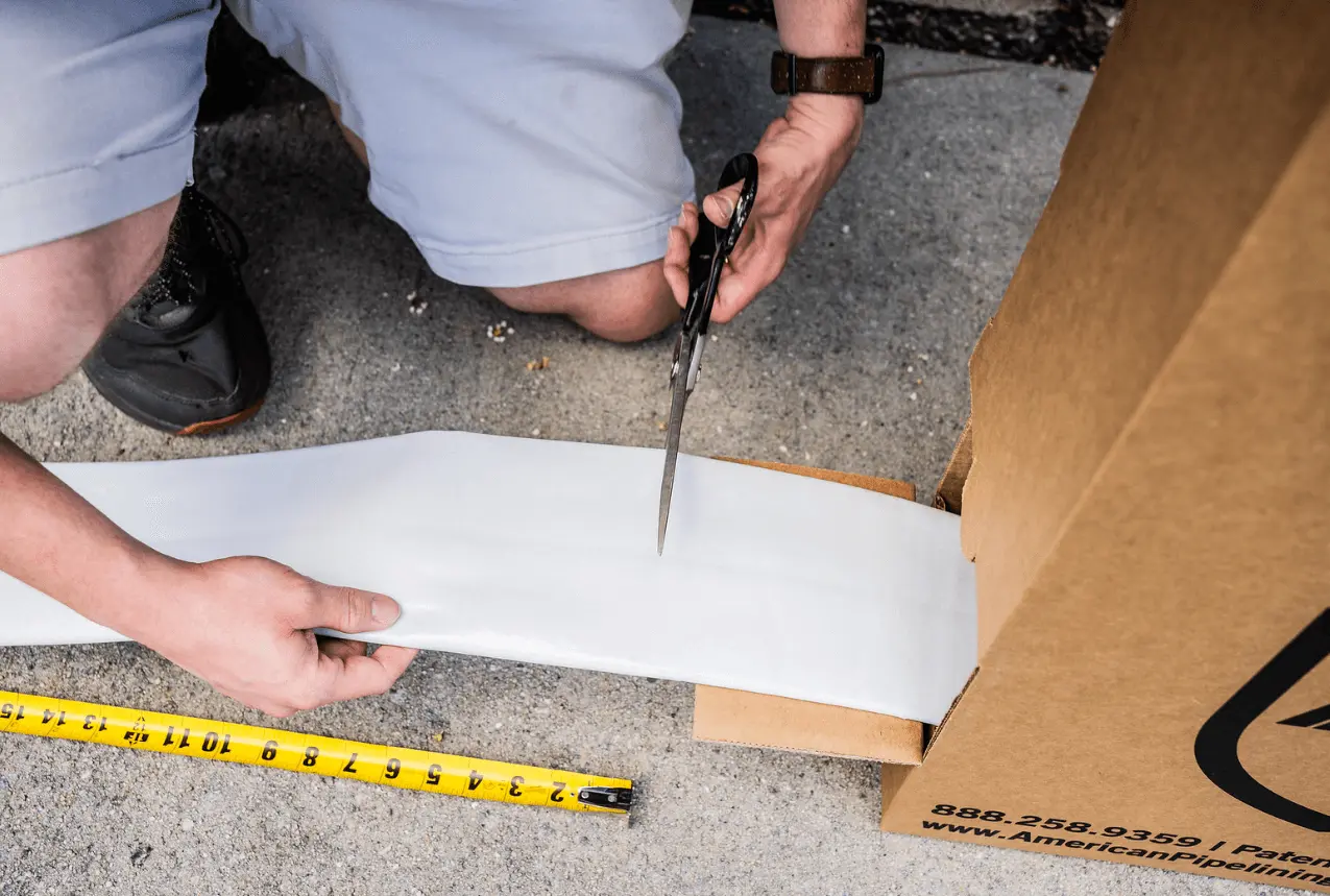 man cutting liner from protect & pull box