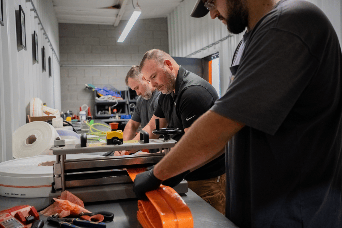 APS technicians preparing liner material during hands-on trenchless pipe repair training.