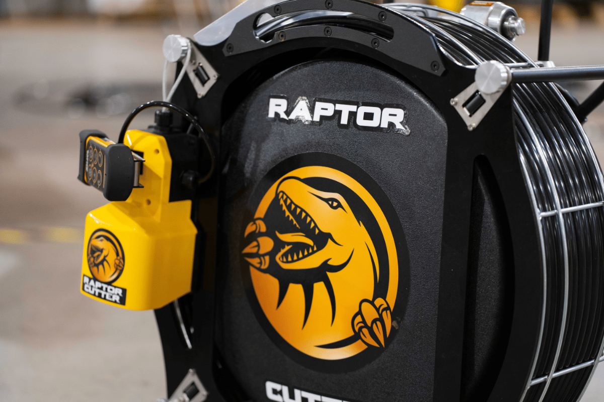 Close-up of the Raptor Cutter high-speed drain cleaning machine and wireless control system for trenchless pipe cleaning and preparation.