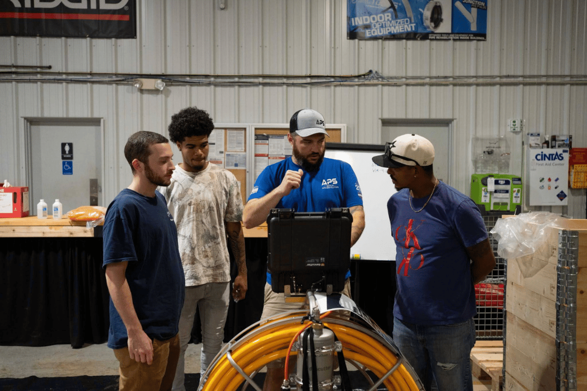APS trainer demonstrating Dancutter equipment to trainees during hands-on APSTA trenchless training.