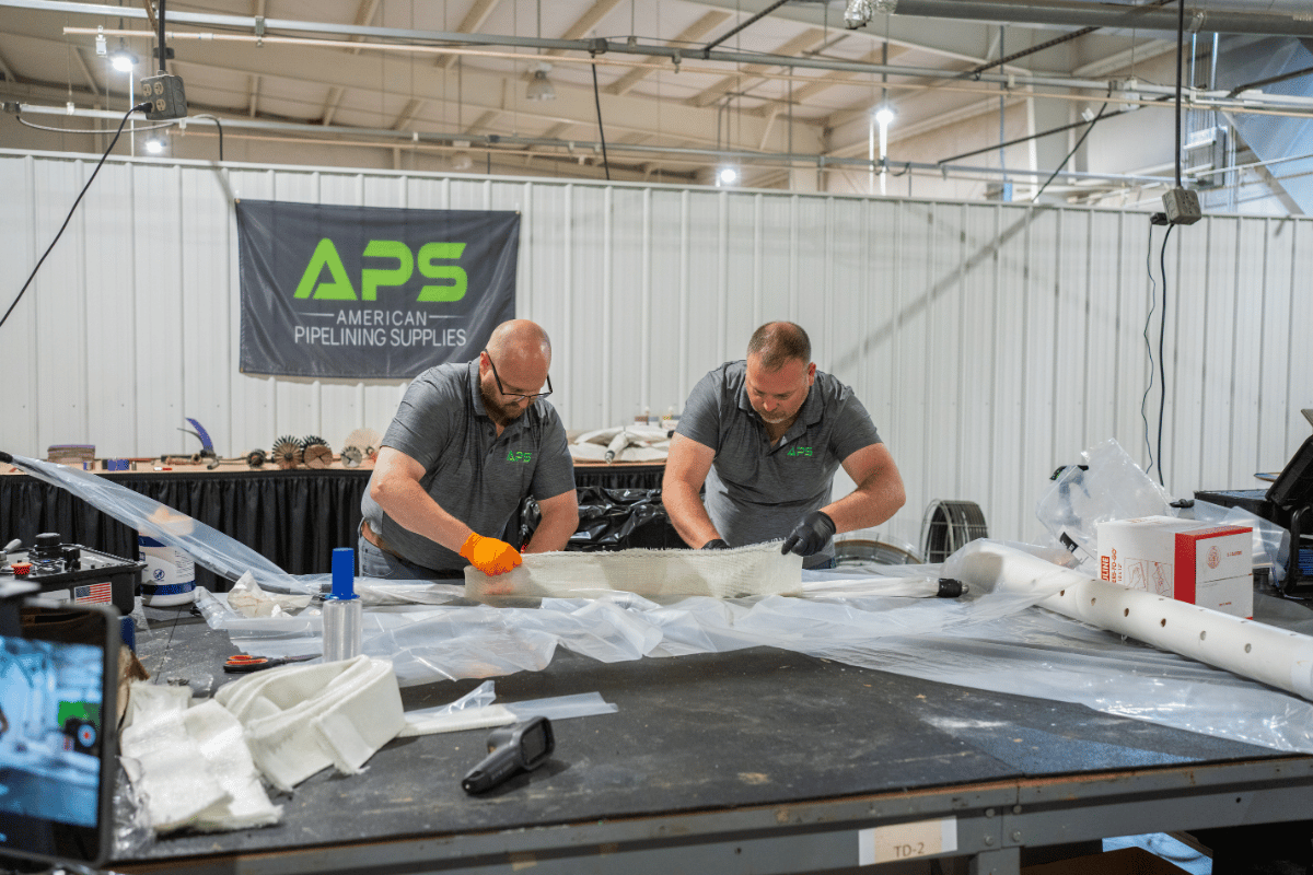 APS technicians preparing fiberglass liner materials for a CIPP pipe lining installation during APSTA training.